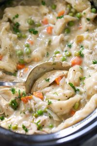 Easy Crock Pot Chicken and Dumplings feature tender chicken breasts cooked in the slow cooker in a rich creamy sauce with biscuit dumplings.