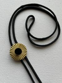 Natural onyx stone and brass on black nylon cord