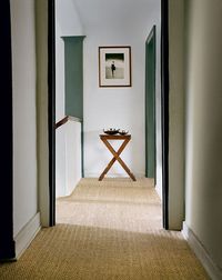 natural carpet, white walls, green woodwork