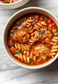 This Italian meatball soup recipe has a tomato broth, and plenty of pasta, garlic, and fresh basil. It's simple to make, and you can use either homemade or store bought (even frozen) meatballs. The perfect cozy family dinner!