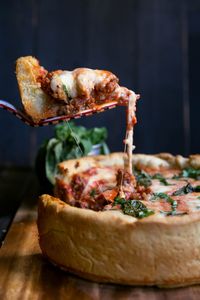 A homemade, Chicago-style deep dish pizza recipe with ooey-gooey cheese and a beautiful, butter-cornmeal crust. This easy deep dish pizza recipe is a must make and you can use any toppings you like. A delicious, indulgent recipe that's perfect for special occasions! #pizza #deepdishpizza #indulgent #dinner #homemadepizza