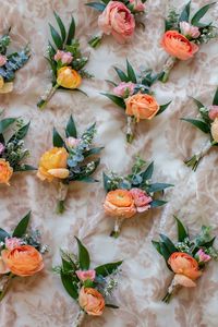 Wedding boutonnières, ranunculus boutonnière, groom, best man, wedding flowers, bridal party, fun, bright, peach, orange, citrus, ruscus, eucalyptus, summer, colorful, color palette, wedding florist, fresh flowers, real flowers, missouri florist, Springfield, Missouri,