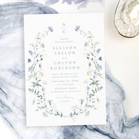 Elegant delicate watercolor wildflower wreath frames your event details, with couple monogram. Pastel palettes of soft yellow, off white, sage green, dusty blue, and botanical greenery, simple and romantic. Great floral wedding invitations for modern rustic wedding, country garden wedding, and boho wedding in spring and summer.