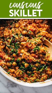 Couscous Skillet with Tomatoes, Chickpeas, and Feta! Steamy, saucy goodness! This Couscous Skillet is packed with vibrant flavors and freshness. Pearl couscous, tomatoes, chickpeas, spices, kale, and a bunch of fresh herbs and feta on top. #couscous #skilletdinner #easyrecipe