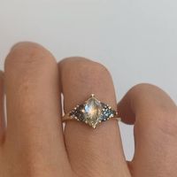 The starburst diamond engagement ring is slightly gothic and represents the hopeless romantic in all of us with its rose cut marquise diamond and teal trillion sapphires.