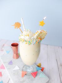 Easy to make adult milkshake this boozy funfetti birthday cake milkshake uses ice cream, cake vodka, and funfetti cake batter to make a delicious alcoholic milkshake. Perfect cocktail for birthdays or parties.