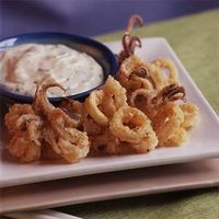 Start with a package of frozen calamari, fry in peanut oil, and serve with a flavorful garlic and lime mayonnaise mixture for an impressive appetizer.