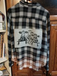 Black and white flannel with sewn patch. One of a kind.