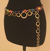 "Daydreamer Belt The inspiration for this beaded belt began with a recently acquired collection of vintage beads from Italy.  Many of these Venetian and Murano glass beads have silver, gold, and copper metallic treatments.  Others are confetti beads, and some are bumpy beads.   They are all so interesting.   For the pendant at the end of the chain I used a single gold lined Italian glass bead that was once an earring.  That bead is exquisite, and the glass has a \"sculpted\" swirl shape.   I com