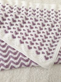 If you wish for a custom one, please let me know! A very unique heart ripple, chevron, zig zag baby blanket in white and purple. Handmade out of very soft yarn suitable for babies that doesn't cause any allergies or itching. A special crochet technique is used to make this double sided blanket!  One side with lovely chevron pattern and the other with this very cute heart pattern! Handmade in a pet and smoke free home. You can wash the blanket in gentle cycle as often as needed and lay flat to dr