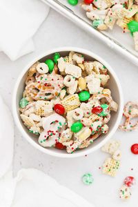 This easy gluten-free christmas chex mix recipe is so fun and festive! It's a perfect holiday treat to share with friends & neighbors and makes a great snack for holiday parties. Crispy, crunchy, sweet, salty, and CUTE, this gluten-free holiday chex mix recipe has everything! Get this no-bake gluten-free holiday snack mix and more easy gluten-free holiday treats to try at Sweets & Thank You (Don't miss our tips for extra pretty chex mix!)