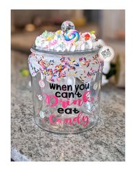 A fake frosting candy jar that includes a fun frosting drip and fake candy frosting topper.  A perfect office candy jar or candy jar for home to store your favorite candy. Item Description: 6 in tall (8.34 Inches with lid attached) Glass Cookie Jar with lid Half gallon jar. 64oz Design is made with outdoor grade vinyl wording that will stay in tact with proper cleaning care (All items come with a product care card) Frosting is made of a silicone material with fake sprinkles and candy designs. De