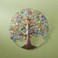 Birds, butterflies, moths, and dragonflies gather. Flowers bloom. Bursting with life and color, Tree of Life is crafted by hand from cut metal, hammered metal, painted metal and wire. Hanging hook on back. About 23" diameter.