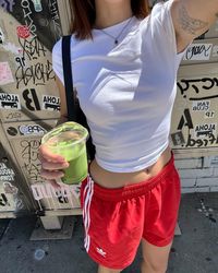 sporty shorts, pop of red, white tee, ballet flats, blokette core, downtown girl, spring outfit inspo, summer outfit inspo, tattoo inspo