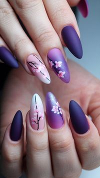 Celebrate the beauty of spring with these enchanting cherry blossom nails! The gentle blend of pastel hues creates a dreamy backdrop for intricate floral art, while the matte purple accents provide a bold touch. Perfect for nature lovers, this design is sure to make a statement and bring a touch of elegance to your look! #nailsdesign #nailsinspo #acrylicnails