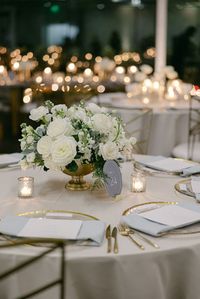 This white wedding floral centerpiece was so gorgeous! We used white roses, white lisianthus, white stock, dusty miller, and a gold container to create the look. The candles were the perfect compliment! Floral by @florafetish | Photography by @honeygemc • • • white wedding flowers white flower centerpieces wedding with candles all white flower wedding centerpieces white flower centerpiece wedding white floral centerpieces wedding low white floral centerpieces wedding