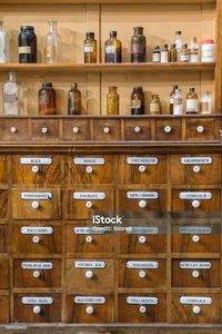 Antique Wooden Drawers of a Chemistry Laboratory and Glass Bottles Antique Wooden Drawers of a Chemistry Laboratory and Glass Bottles. Pharmacy Stock Photo