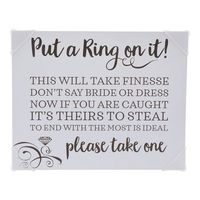 Don't say bride or dress. This bridal shower game sign spells out the instructions for a fun wedding shower activity that will get the guests moving interacting and giggling during the future wife's pre-wedding bash. If one guest catches another saying either word they can take their ring. Whoever ends up with the most rings wins. Find more bridal shower supplies and decorations on this website. Chipboard. 10" x 8" Oriental Trading Company | Oriental Trading Company Bridal Shower Sign 0.25 H x 8