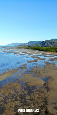 We took this shot of Port Douglas Australia ' s beautiful Four Mile Beach at low tide using a drone. Our post is on the best times to visit Port Douglas, Queensland Australia. This drone photo was taken in May. Port Douglas travel bloggers, local guide.