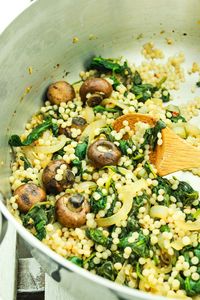 ISRAELI COUSCOUS WITH SPINACH AND MUSHROOMS – This recipe for Israeli couscous puts dinner on the table in 25 minutes. It's mixed with a savory blend of sautéed garlic, mushrooms, and spinach.