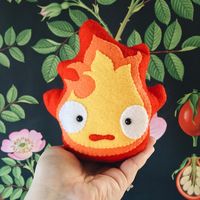 “A closer look at the little felt calcifer from my #ghibliswap package.  I'm pretty pleased with that little grimace.  I'll probably end up making one for…”