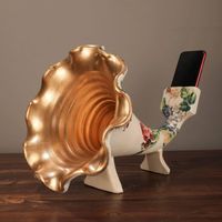 For anyone who enjoys fine craftsmanship, this Gramophone Phone Speaker Floral Sculpture is the perfect gift. Made to fit every smartphone, this natural gramophone speaker is hand-painted by skilled artisans in Turkey. Every piece is unique and well made, suitable for gifting anyone of any age, from your grandma to your boss. Material: Polyester, Acrylic Paint Size: Approx. 13.7" x 10.2" x 10.2" Care: keep dry Shipping Note: Due to the high import tax, this article cannot be shipped to Saudi Ara