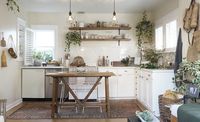 Tiny home kitchen with white quartz countertops, open-shelving and white cabinets