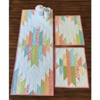 Liven up your kitchen table with Cut Loose Press's Reflections Table Runner & Placemats Pattern. This intermediate skill level design uses Creative Grids' XL Folded Corner Clipper Tool and 10" fabric squares (not included). Once completed, the table runner finished to 15" by 38" and the placemats measure 12" by 15". Detailed instructions and a suggested materials list is included with the Reflections Table Runner & Placemats Pattern.   Love Cut Loose Press? Keep all of your patterns organized with the Cut Loose Press Pattern Binder!   Specifications:  Project Size: 15" x 38" (Runner), 12" x 15" (Placemats)  Project Length: 6+ Hours  Project Type: Home Decor  Fabric-Cut Type: Charm Squares   Love Cut Loose Press? Keep all of your patterns organized with the Cut Loose Press Pattern Binder!