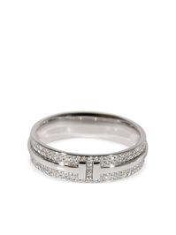 18kt white gold pavé setting white diamonds totalling 0.57ct eternity band signature Tiffany T design polished finish Condition: EXCELLENT. This previously owned item is in near-perfect condition with no signs of damage or use. Purchasing this item continues its narrative and reduces the environmental impact by avoiding the use of new resources needed to make the product from scratch, such as water, materials and electricity, and avoiding additional manufacturing impact. Learn more about what makes a product Conscious on our Conscious Criteria page