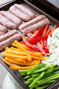 Blackstone brats with peppers and onions is a simple dinner. This Blackstone griddle recipe is so easy, and loaded with flavor in each bite. Butterfly cut bratwurst, piled high with peppers and onions on a toasted hoagie bun. A simple but tasty meal to make for any night of the week. #grill #flattop #blackstone #blackstonegriddle #grilling #brats #bratwurst