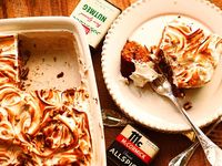 Instead of those puffed up mini-marshmallows, this Ode to a Casserole Cake is mounded with a spiced and spiked, pecan-flecked Italian meringue frosting that bronzes and crisps under the blaze of a hot flame.