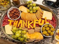 thanksgiving charcuterie board!🧡 salami, rosemary entertaining crackers, cheddar cheese, gruyère cheese, spicy jalapeño cheese, cracked black pepper triscuits, garlic-stuffed olives, garlic almonds, & green grapes — all purchased from vons!