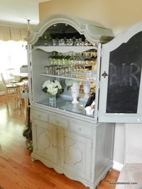 A Stylish Interior: Paula Deen Bar Armoire (i'm in love. I want our glasses organized and hanging on racks, but still sort of hidden so as not to collect too much dust)