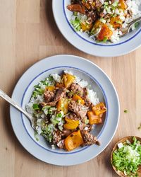 Mom's pepper steak served with rice and topped with scallions.