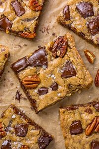 Brown Butter Bourbon Pecan Chocolate Chunk Blondies are chewy, crunchy, and loaded with gooey pockets of chocolate! The bourbon gives them a subtle kick without being overpowering!