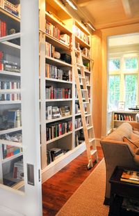 built in book shelves, living room, pocket door with glass, book shelf ladder