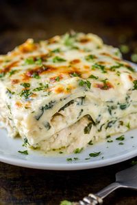 This white sauce Chicken Lasagna is so satisfying with layers of lasagna noodles and tender chicken in a creamy spinach sauce.