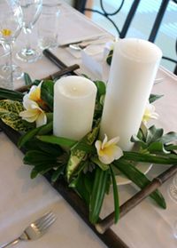 Tropical wedding centerpiece with white pillar candles - beach Ideas and inspirations - summer beach theme.