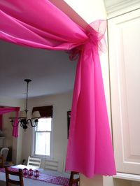 A DIY Barbie birthday party with lots of pink decor. Easy ruffled tablecloth, DIY Barbie favors, a wall mounted TV cover, cupcake stand and more.