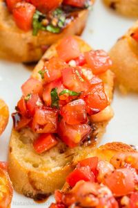 Authentic Italian Bruschetta! Learn how to make a crowd-pleasing tomato bruschetta. The parmesan toasts and drizzle of balsamic make these irresistible.