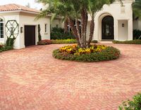 This driveway uses a variety of designs, like herringbone, running bond and stack bond to compliment the landscaping and architecture of the space. Pine Hall Brick.