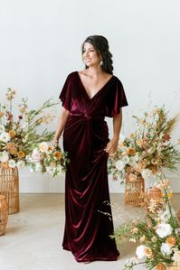 Our graceful Gwen dress is an excellent modest look as it offers more coverage with its wide V-neckline and angel sleeves! This velvet dress comes with built-in bra cups and a front twist detail that adds sophistication to a timeless silhouette.