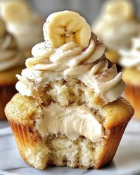 Moist banana cupcakes filled with cream cheese and topped with fluffy frosting. A delicious treat that's easy to make and irresistible to all!