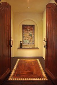 African Safari Style House by JMAD, James McNeal Architecture & Design. Creative architecture firm specializing in high end luxury commercial & residential design. Africa inspired dream home/stone home. Arched display/art niche hallway. Custom wood doors custom animal horn handles. Wood floor detail design. #dreamhome #alcove #archedalcove #niche #archedniche #artniche #displayniche #interior #architecture #customwooddoors #wooddoors #animalhorn #handles #customhandles