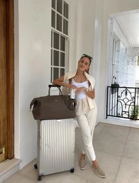 Discover 8 classy and comfy summer airport outfits perfect for your next flight! These trendy looks combine cute, casual, and cozy elements to keep you feeling fabulous and relaxed during your travels. For example, we just love this athleisure look with white joggers, a white tank top, a Rimowa suitcase and Loro Piana loafers!