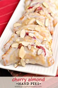 Easy, baked Cherry Almond Hand Pies! A flaky crust with a cherry almond pie filling, dipped in a sugary glaze and topped with sliced almonds. The perfect dessert!