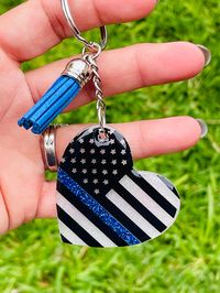 Keychains are handmade heart shape American Flag with a blue line.  Keychains measure about 2" width and its covered with a coat of resin. Keychain comes with a tassel.                          Care Instructions 1- Keychain may break if knocked against a hard surface or    dropped. 2- AVOID prolonged exposure to heat or water. 3- Cleaning carefully with a soft cloth or use some water. 4- Avoid using any alcohol-based cleaners.         DO NOT USE ALCOHOL TO CLEAN Keychain makes a great gift idea