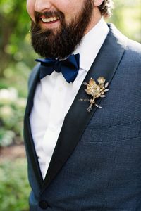 Courtney's antique myrtle boutonniere, a glowing tarnished silver, matched Britt's leafy antique tiara. The German wedding symbol was apt for the nature-loving couple, who found the ensemble through Polly McGeary. It popped against the groom's Isaia suit.