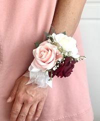 💐 Stunning burgundy, blush, and cream rose wrist corsage with greenery and ribbon accents.  💐 Please message me for wedding party packages or if you like any modifications to this corsage