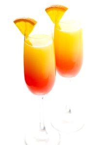 Tequila sunrise cocktails meet mimosas in this gorgeous, bubbly recipe! Feel free to use traditional tequila, or you can try mezcal for a smoky kick!